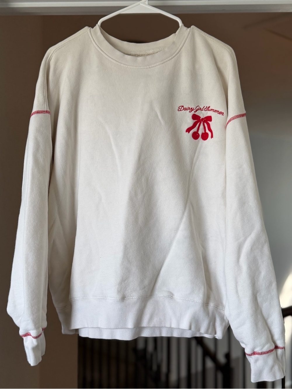 Cozy Cream Crewneck Sweatshirt with Red Cherry Accent